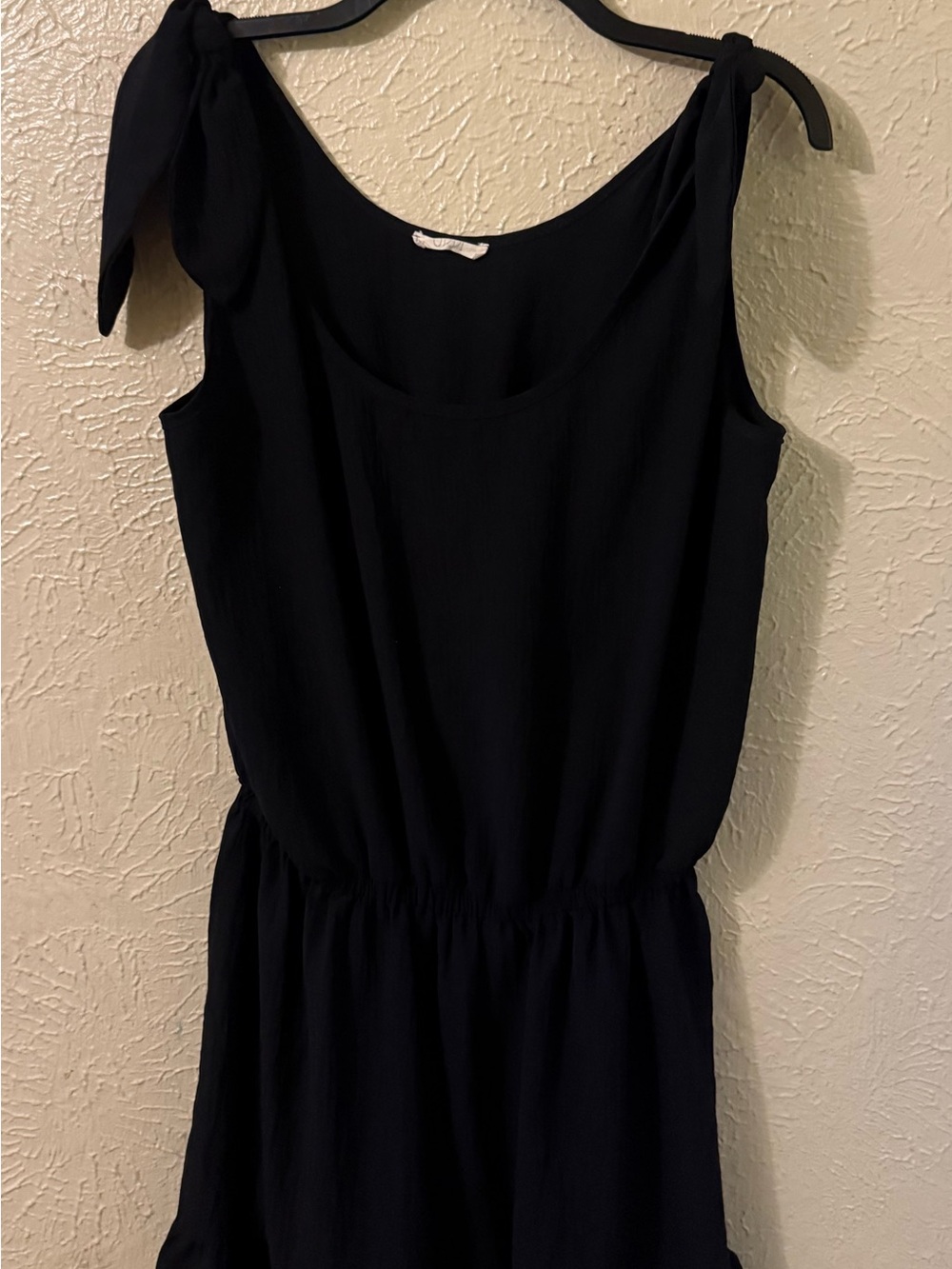 Women’s Black Sleeveless Romper with Tie- Shoulder Straps and Ruffle Hem